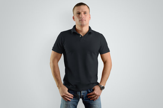 Mockup black  polo shirts.  Athletic man is isolated on a gray background.