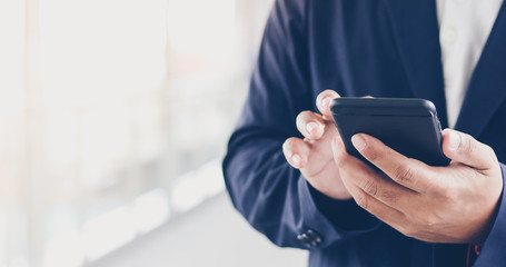 Businessman asian using phone for celling and texting on her mobile phone