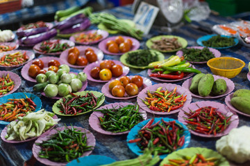 Vegetables, spices, roots and herbs on the counter, the local market in Thailand
