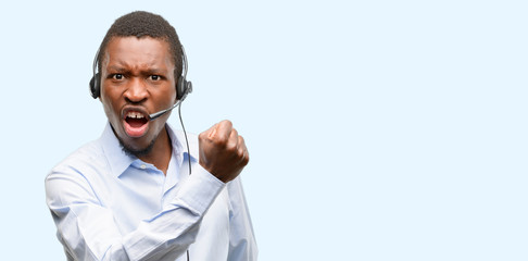 Black man consultant of call center irritated and angry expressing negative emotion, annoyed with someone