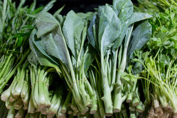 Obraz premium Vegetables, spices, roots and herbs on the counter, the local market in Thailand