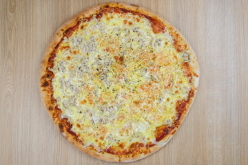 Pizza delicious classic style on wooden table background. Fresh food variety, closeup top view promotional photo. Italian traditional culture