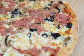 Pizza delicious classic style on wooden table background. Fresh food variety, closeup top view promotional photo. Italian traditional culture