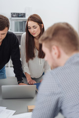 Group of young people in an office brainstorming