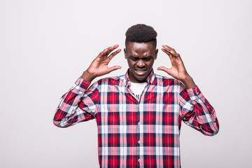 Fototapeta premium Oh no. Attractive unhappy dark-eyed afro-american man wearing a white shirt and looking dissatisfied and having his hands on his head