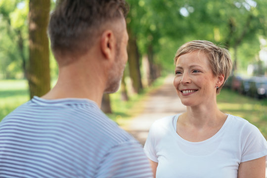 Smiling mature woman looking at man in park