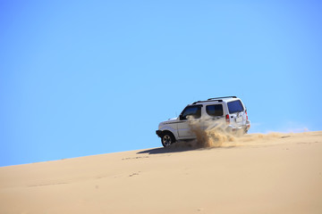 Fototapeta na wymiar An suv was driving in the desert.