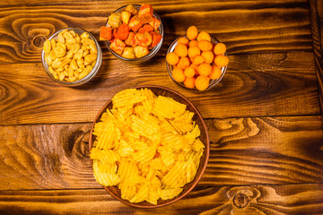 Different snacks for beer on wooden table. Top view