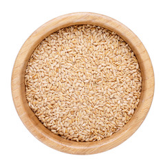 Golden flax seeds in wooden bowl isolated on white. Top view.