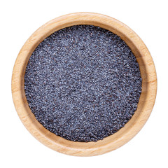 Poppy seeds in wooden bowl isolated on white. Top view.