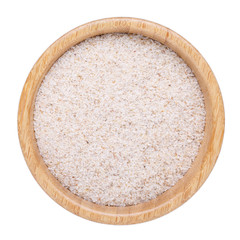 Whole psyllium husks in wooden bowl isolated on white.