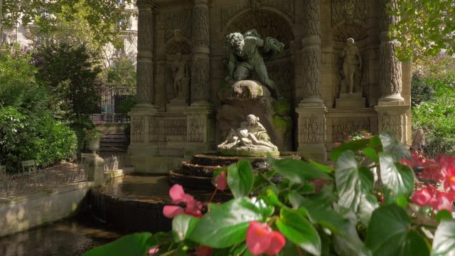 PARIS, FRANCE - SEPTEMBER 29, 2017: People relaxing near Medici Fountain in the Jardin du Luxembourg. It was built in about 1630 and extensively rebuilt in 1864-66
