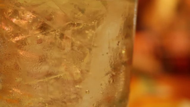 close-up beverage refreshment, glass drink with ice and gas bubble floating in water