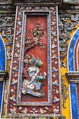 Vietnam, Hue. Decoration  decorated with pieces from broken ceramic dishes at Imperial City on the one of five entrance gates to the Forbidden city complex in Citadel.