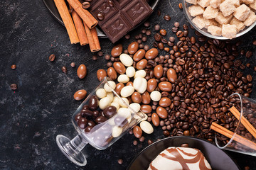 Tasty and sweet candies on dark wooden background