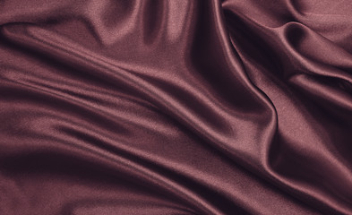 Smooth elegant pink silk or satin luxury cloth texture as abstract background. Luxurious background design