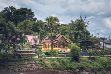 Fototapeta na wymiar traditional buddhist temple among nature in thailand with film look in thailand