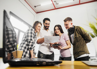 Team of office workers have friendly discussion, indoor shot in modern office