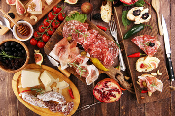 Italian antipasti wine snacks set. Cheese variety, Mediterranean olives, pickles, Prosciutto di Parma and salami
