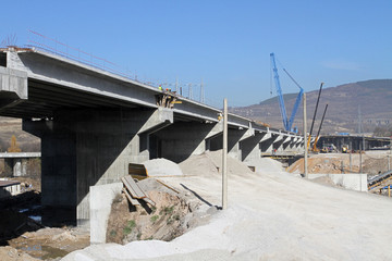 New highway under construction. A new bridge freeway made of concrete and metal to pass traffic...