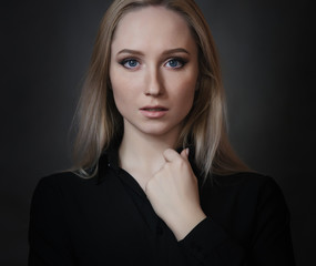 Portrait of beautiful young woman with blue eyes. Studio shot.