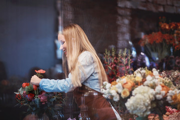 Fototapeta na wymiar Young florist with flowers