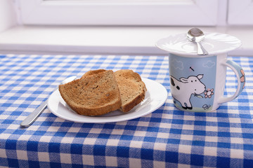 a cup of tea, a piece of toast with honey for breakfast