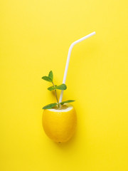 Lemon with white straw and mint.