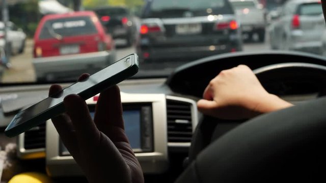 slow motion, one person using mobile phone in car driving