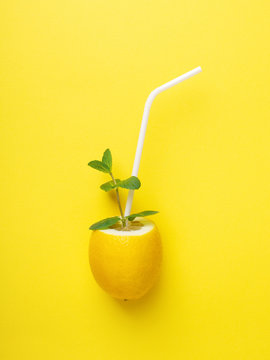 Naklejki Lemon with white straw and mint.