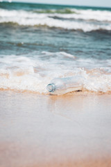 Plastic bottle in ocean water, littering the sea concept image