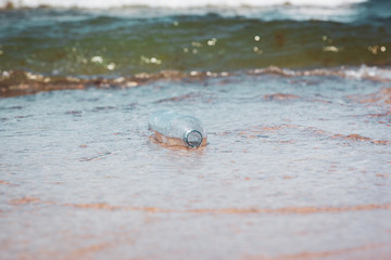 Plastic bottle in ocean water, littering the sea concept image