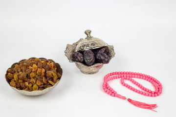 Islamic Ramadan Muslim iftar sehoor morning meal breaking fast, religious fasting with traditional silver plates and raisins