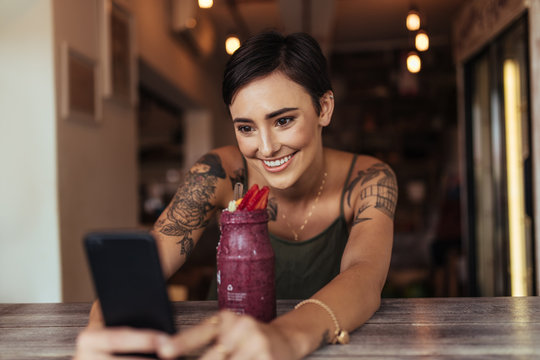 Woman taking a selfie for her food blog