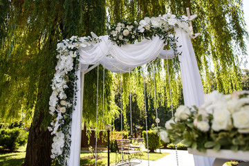 Wedding arch with fresh flowers for wedding ceremony. Beautiful wedding decor, decoration