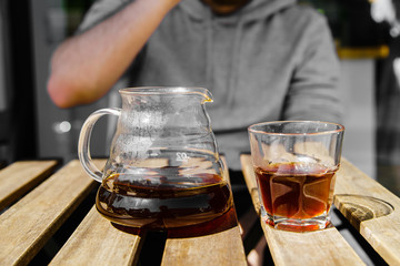 Drinking alternatively brewed coffee at the sunny street cafe from glasses.