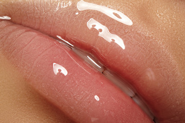 Moisturizing lip balm, lipstick. Close-up of a beautiful sexy wet lips. Full lips with gloss makeup. Filler Injections - obrazy, fototapety, plakaty