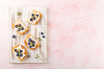 Toast with fresh berries blueberry Ricotta cheese, thyme, honey and hazelnuts, served