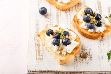 Toast with fresh berries blueberry Ricotta cheese, thyme, honey and hazelnuts, served