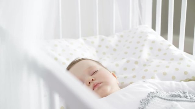 Cute baby girl sleeping in the crib