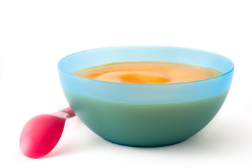 Baby food: blue bowl with fruit puree isolated on white background