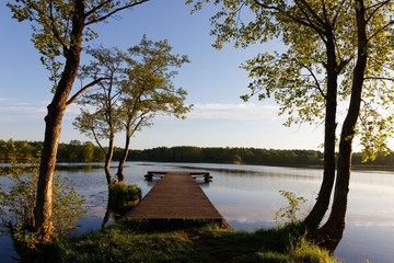 Obraz premium Wooden pier at sunrise, lake Skoki, Poland