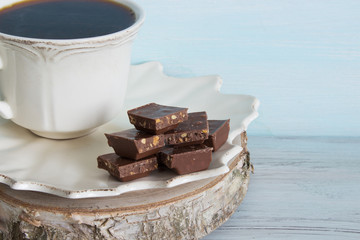 A cup of coffee with pieces of chocolate. Breakfast.