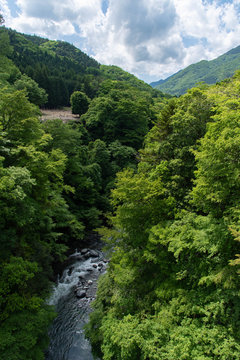 A river flowing through a country valley in Japan