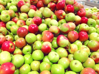 Many fruits green, red apples lying at supermarket close-up