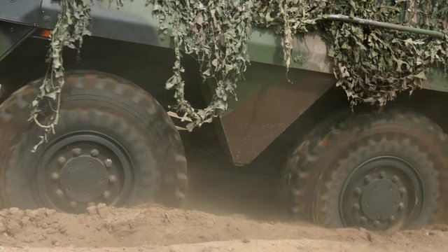 Armored military vehicle 8x8 wheeled BTR driving offroad in sand desert