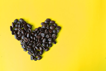coffee bean in heart shap on yellow background