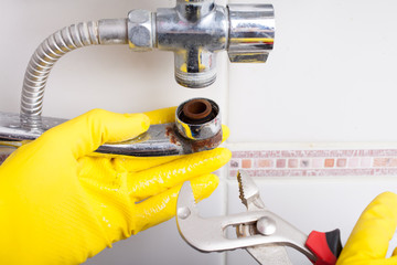 Plumber service. worker installing mixer tap