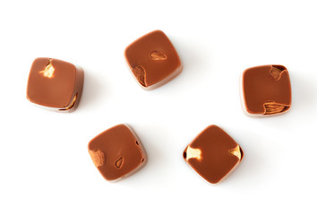 Assortment of chocolate candies sweets isolated on a white background. Chocolate candies collection. Milk chocolate with nuts.
