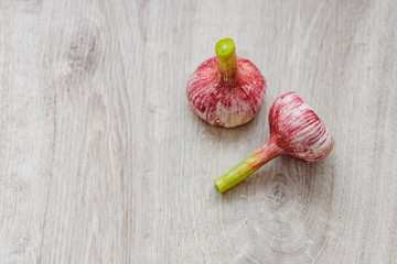 Fresh young garlic straight from the garden to the kitchen on a wooden background